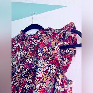 Short sleeve blouse with ruffle sleeves and key hole button back